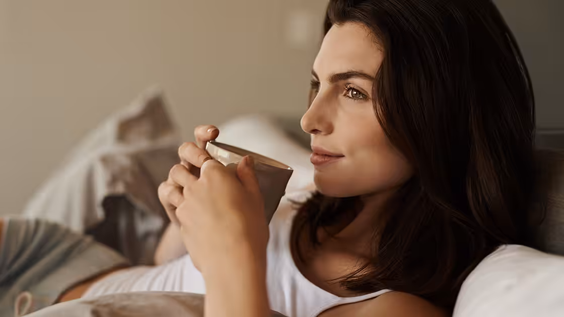 Woman relaxed with coffee - sedation dentistry
